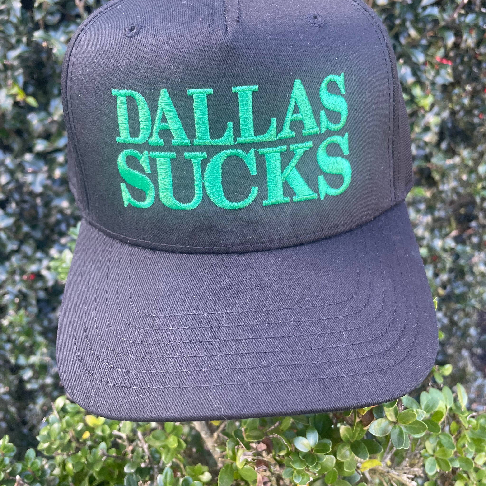 DALLAS SUCKS- BLACK TRUCKER HAT KELLY GREEN THREAD